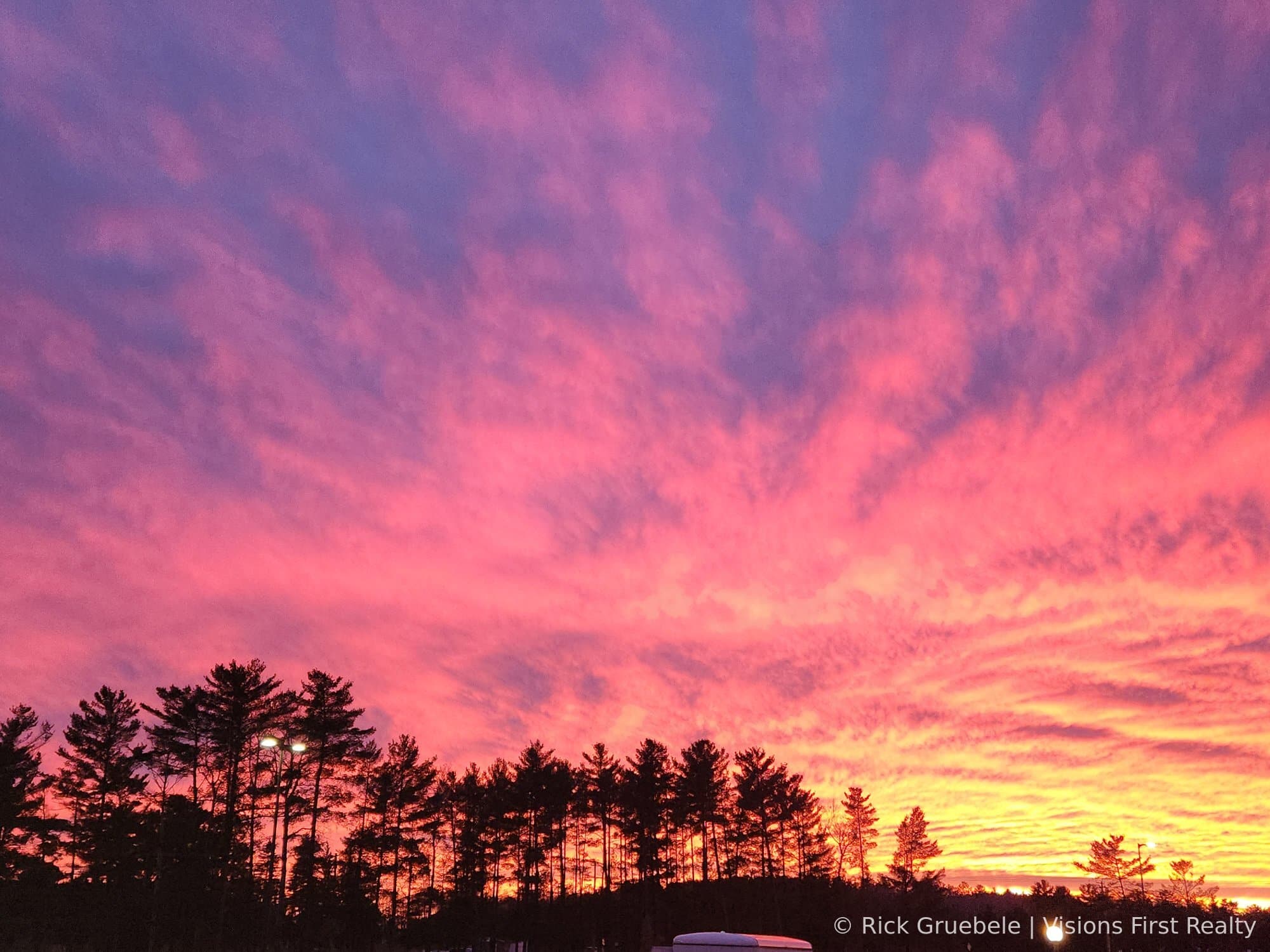 Northwoods sunset through pine trees — Ashland County WI real estate